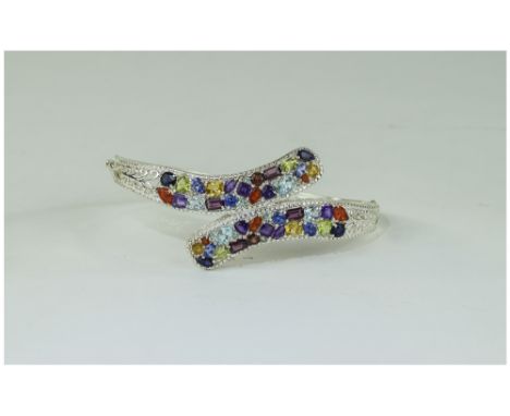 Multi Gemstone Crossover Bangle, set with fire opal, amethyst, sky blue topaz, peridot, rhodolite garnet and red garnet, tanz