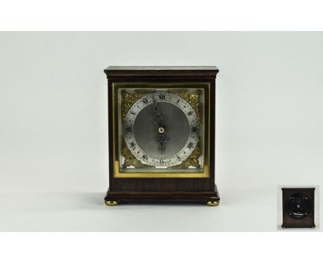 Elliot Mantel Clock with Silvered Chapter Ring, Ornate Fingers, Raised on Four Ball Feet. Height 6 Inches, Width 4.75 Inches.
