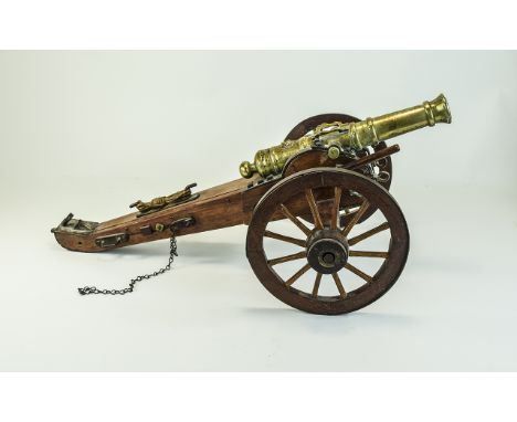 Good Quality Vintage Replica British Artillery Brass Cannon, features metal trimmed rotating wheels, wood carriage and 10 inc