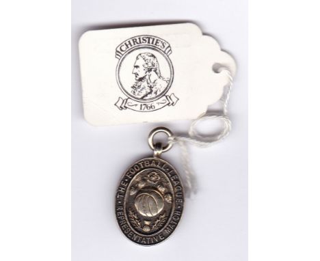 FOOTBALL LEAGUE MEDAL       A hallmarked silver-guilt oval medal issued to a player of the Football League who played against