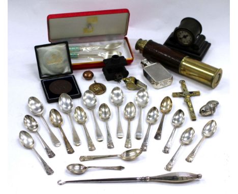 A SMALL GROUP OF SILVER TEASPOONS together with a silver babies rattle in the form of an acorn, a miniature camera, a telesco