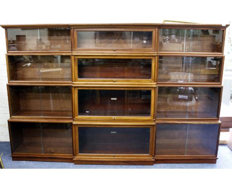 A HARDWOOD BREAKFRONT BOOKCASE with lifting and sliding doors, some sections bearing Globe Wernicke labels and also with a ca