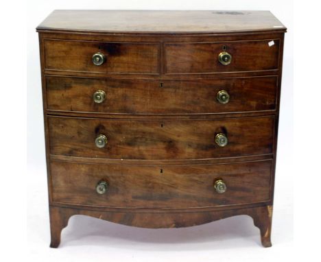 A GEORGE III MAHOGANY BOW FRONTED CHEST OF TWO SHORT AND THREE LONG DRAWER with turned brass handles and outswept bracket fee