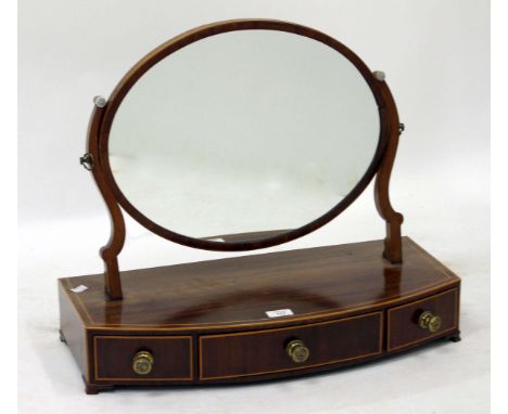 A 19TH CENTURY MAHOGANY AND SATINWOOD BANDED BOW FRONTED DRESSING TABLE MIRROR, the oval swinging mirror above three short dr