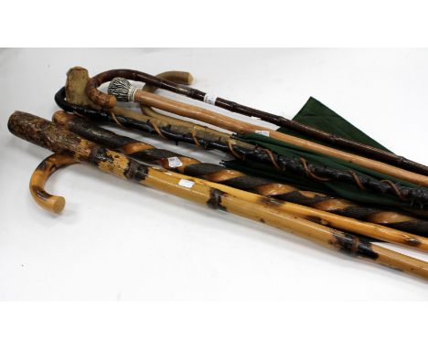 SIX ANTIQUE AND LATER WALKING CANES and a vintage umbrella (7)