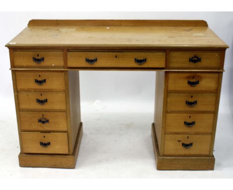 A LIGHT OAK PEDESTAL DESK with galleried back, 137cm wide x 195cm high