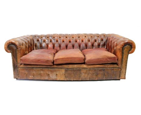 A BROWN LEATHER BUTTON UPHOLSTERED CHESTERFIELD with studded details 