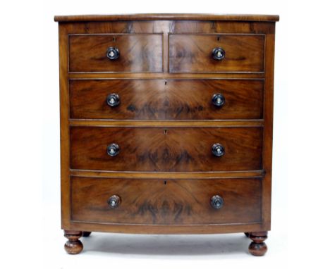 A 19TH CENTURY VICTORIAN FLAME MAHOGANY BOW FRONTED CHEST OF TWO OVER THREE DRAWERS on bun feet, 120cm x 107cm x 55cm