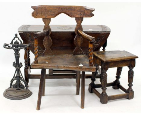 AN ANTIQUE OAK GATELEG TABLE with oval chip carved top 104cm wide together with an old oak joint stool, a black painted cast 