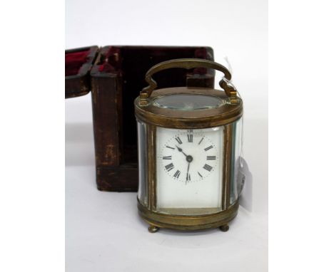AN ANTIQUE LEATHER CASED BRASS CARRIAGE CLOCK with white enamel face and black Roman numerals and ribbon handle 