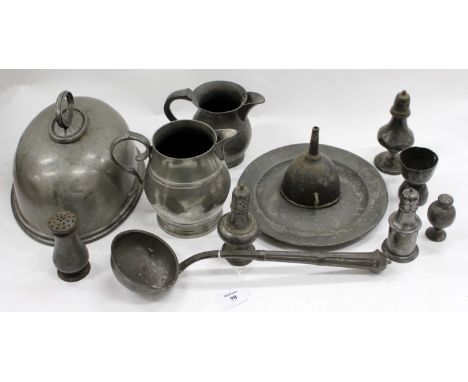 A SMALL GROUP OF PEWTER WARES consisting of a 19th century ladle, various pepper pots, a meat cover, two jugs, a double ended