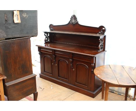 A VICTORIAN STYLE SIDE CABINET the raised carved back with shelf on pierced foliate supports, all over three frieze drawers a