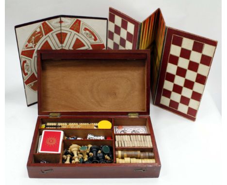 A MAHOGANY BOXED GAMES SET and contents therein including playing cards, cribbage board, dominoes, draughts, lead jockeys, co
