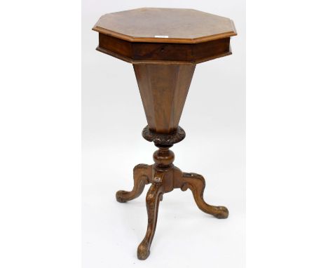 A VICTORIAN WALNUT OCTAGONAL WORK TABLE with bone and ivory needlework tools within, the table standing on a tripod base 44.5