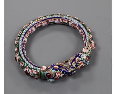 An Indian enamelled and foil backed paste? set white metal bangle.