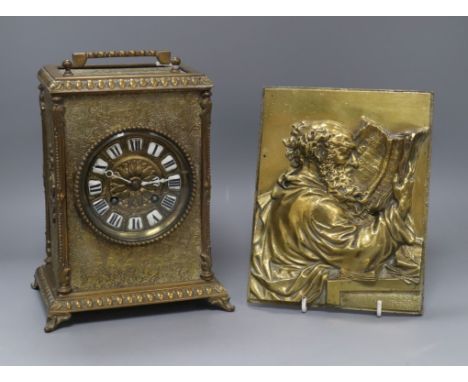 A German brass portrait plaque and a brass mantel clock