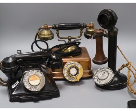 A candlestick phone, a brass telephone and a bakelite telephone
