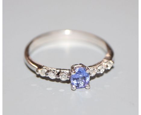 A modern 18ct white gold, tanzanite and diamond dress ring, size O.