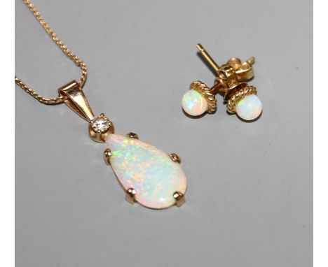 A yellow metal, white opal and diamond set pendant, on a 9ct chain and a pair of 585 and white opal ear studs.