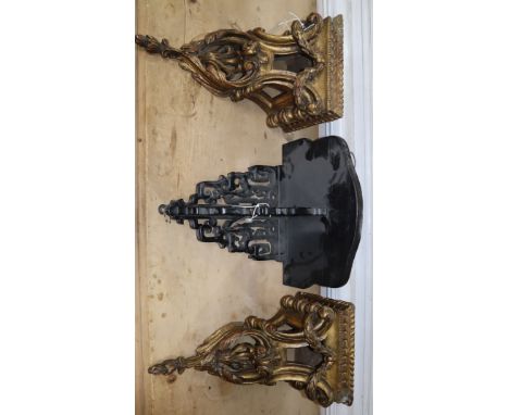A pair of wall brackets, carved with acanthus leaves and laurel swags and an ebonised bracket