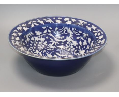 A 19th century Chinese white slip decorated blue ground basin diameter 34cm