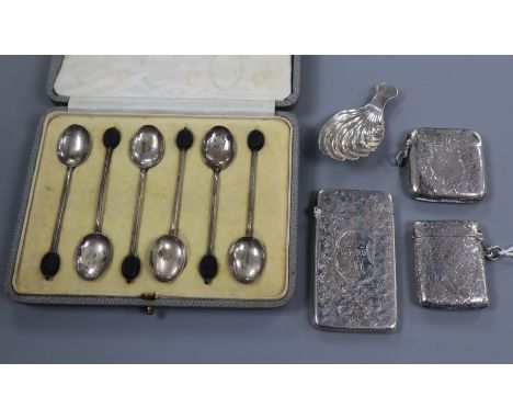 A silver caddy spoon, a silver card case, two silver vesta and a cased set of six silver bean end coffee spoons.