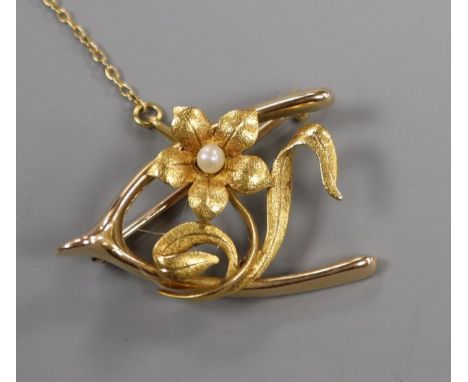An early 20th century 15ct and seed pearl set flower and wishbone brooch, 31mm.