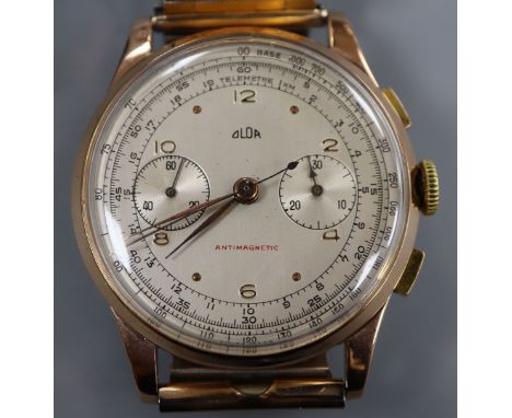 A gentleman's 1950's? 750 yellow metal Swiss Olor chronograph manual wind wrist watch, on associated flexible strap.