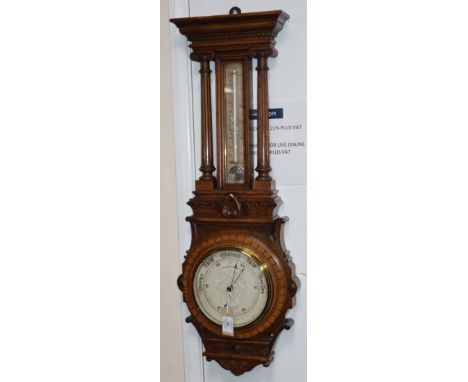 A Victorian carved oak aneroid barometer with thermometer H.92cm