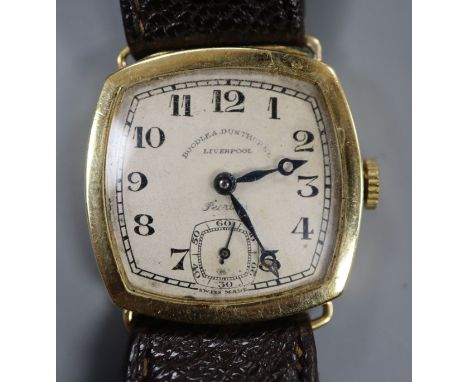 A gentleman's late 1920's 18ct gold manual wind wrist watch, retailed by Boodle &amp; Dunthorne, on associated strap.