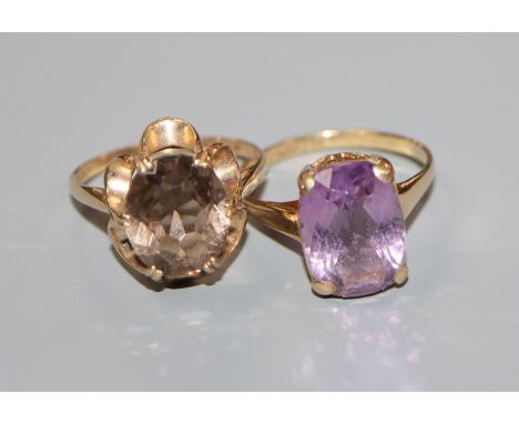 A 9ct gold and smoky quartz cocktail ring and a similar amethyst ring.