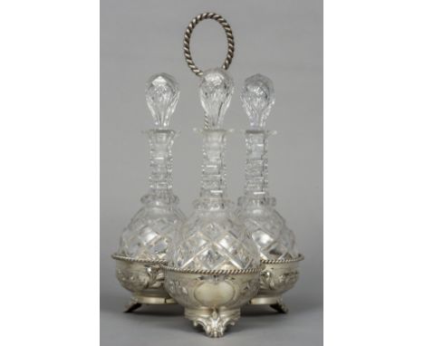 A 19th century silver plated triple decanter stand by Martin Hall & Co.
Each cut glass decanter and stopper housed in a flora