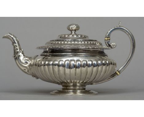 A George IV silver teapot, hallmarked Edinburgh 1821, maker's mark of JWH
Of bulbous stop reeded form with acanthus cast scro
