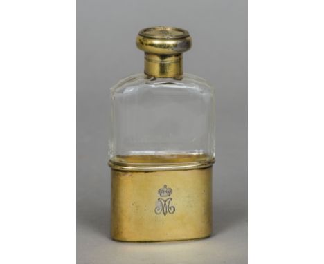 A silver gilt mounted facet cut clear glass hip flask, the collar and lid hallmarked London 1913, the cup hallmarked London 1