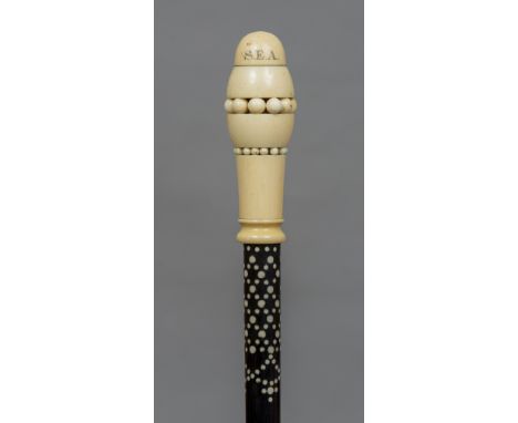 An Anglo-Indian ebony and ivory walking stick
The ivory handle with inset nodules inscribed S.E.A., the spiralled ebony shaft