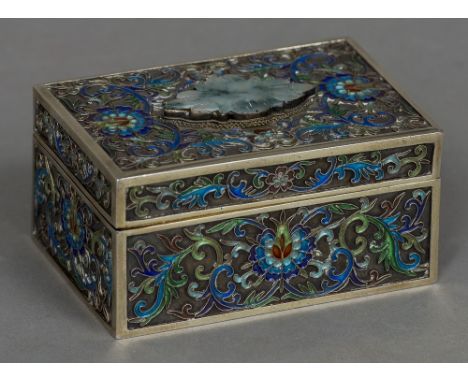 A Chinese enamel and jade mounted Sterling silver box
Of rectangular form, the removable lid centred with a jade floral plaqu