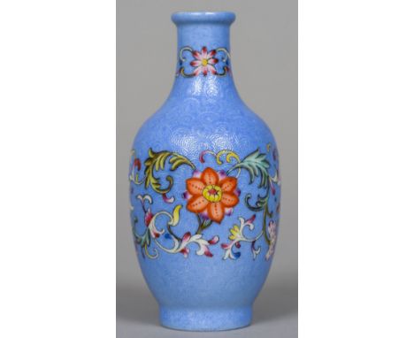 A Chinese porcelain vase
Decorated with lotus strapwork bands on a scroll incised blue ground, blue painted four character Qi