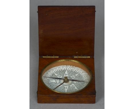 A George III mahogany cased compass
The hinged cover enclosing a glazed 3.75 inch printed paper dial, the hands with brass se