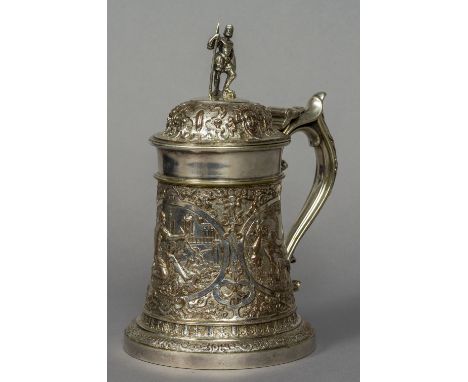 A 19th century silver plated tankard
The hinged lid surmounted with a knight form finial, his shield engraved with a crest ab