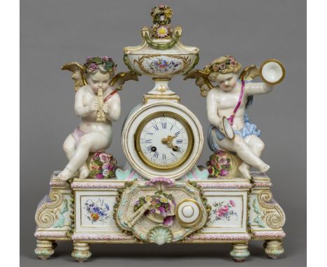 A Meissen type porcelain cased mantle clock
The white enamelled dial with Roman and Arabic numerals, the floral encrusted and