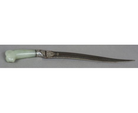 An 18th/19th century Eastern dagger
Set with a jade handle with ram's mask finial, the blade with white metal inlaid decorati