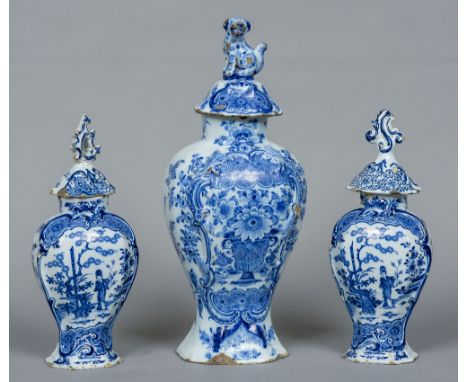 An 18th century Dutch Delft triple garniture by Johannes Van Duijn
Comprising: a large vase and cover and a pair of smaller v