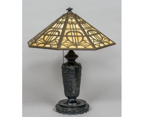 A late 19th/early 20th century Japanese cast iron table lamp
Of vase form, decorated with various floral filled vignettes, wi