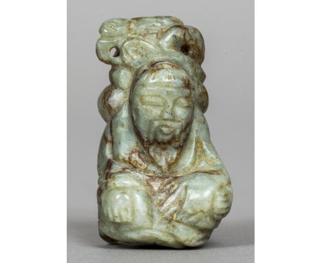 A Chinese carved green and russet jade figure
Modelled as a cross legged sage.  5 cm high. CONDITION REPORTS: Generally good 