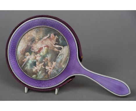 An enamel backed dressing table mirror
Centred with a painted ivory portrait miniature depicting two women and cherubs before