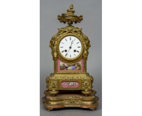 A 19th century French ormolu mantel clock
The urn finial above the white enamelled dial with Roman numerals inscribed D.C. Ra