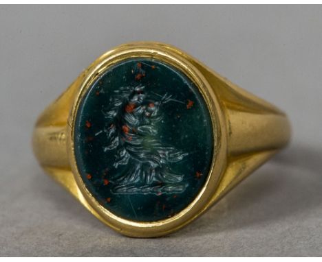 An 18 ct gold bloodstone set intaglio carved signet ring
Worked with a lion's head crest.  CONDITION REPORTS: Generally in go