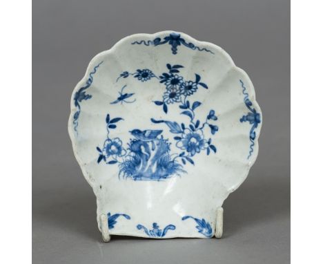 A mid 18th century Worcester blue and white pickle dish
Moulded as a scallop shell and painted with the two peony rock bird p