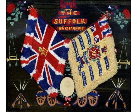 A Suffolk Regiment Memorial woolwork picture
Worked with Regimental flags and military accoutrements, centred with a photogra
