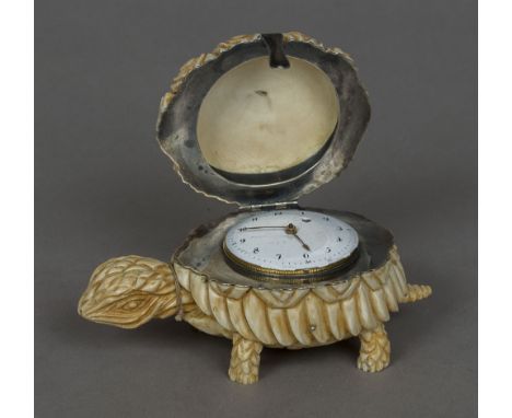 An unmarked silver mounted carved ivory model of tortoise
The hinged lid enclosing a clock with white enamel dial with Arabic